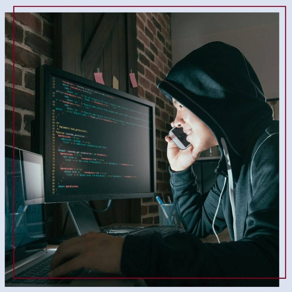 criminal looking at code on computer